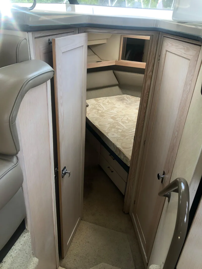 Slide: The Image of 1996 Bayliner 3587 Motoryacht interior cabin with bed and wooden cabinetry. - 26