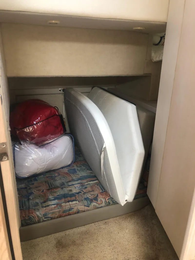 Slide: The Image of 1996 Bayliner 3587 Motoryacht interior storage area with cushions and bags. - 28