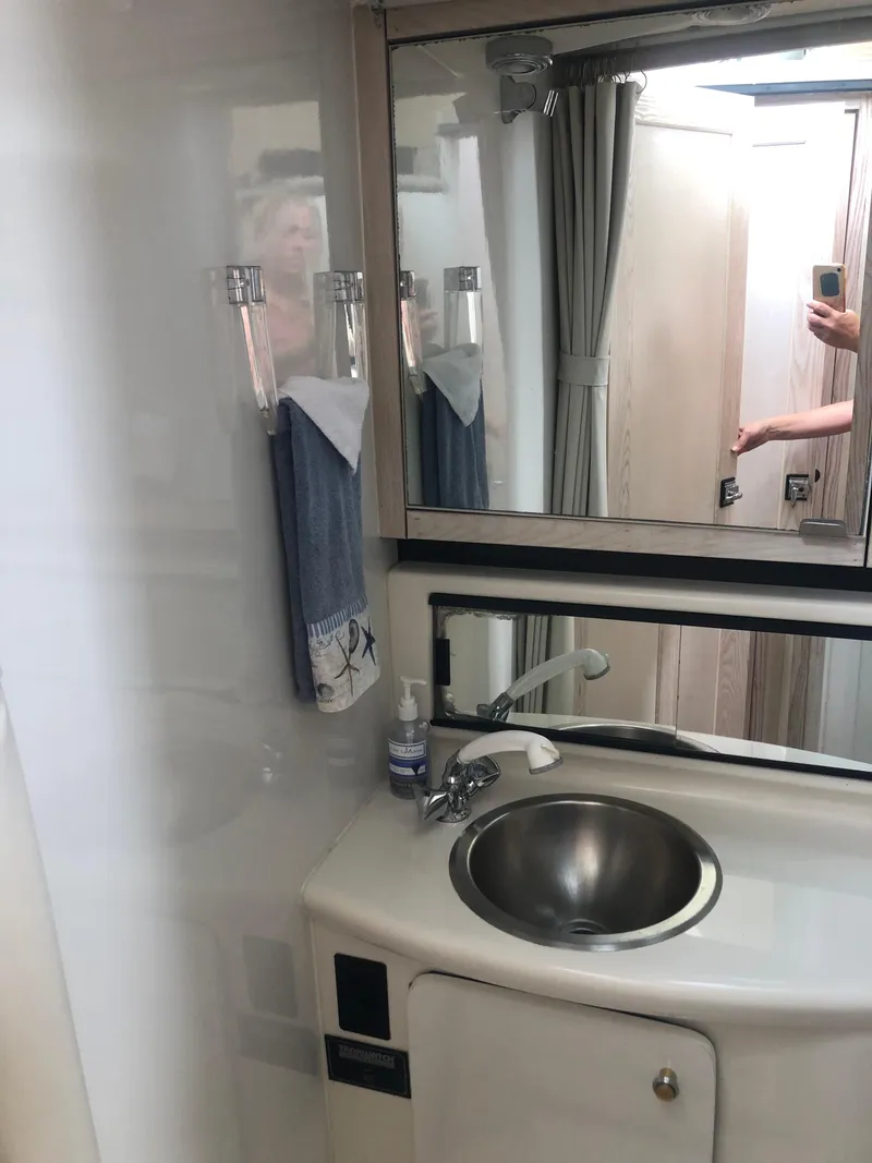 Slide: The Image of Bathroom interior of 1996 Bayliner 3587 Motoryacht with sink and mirror. - 31