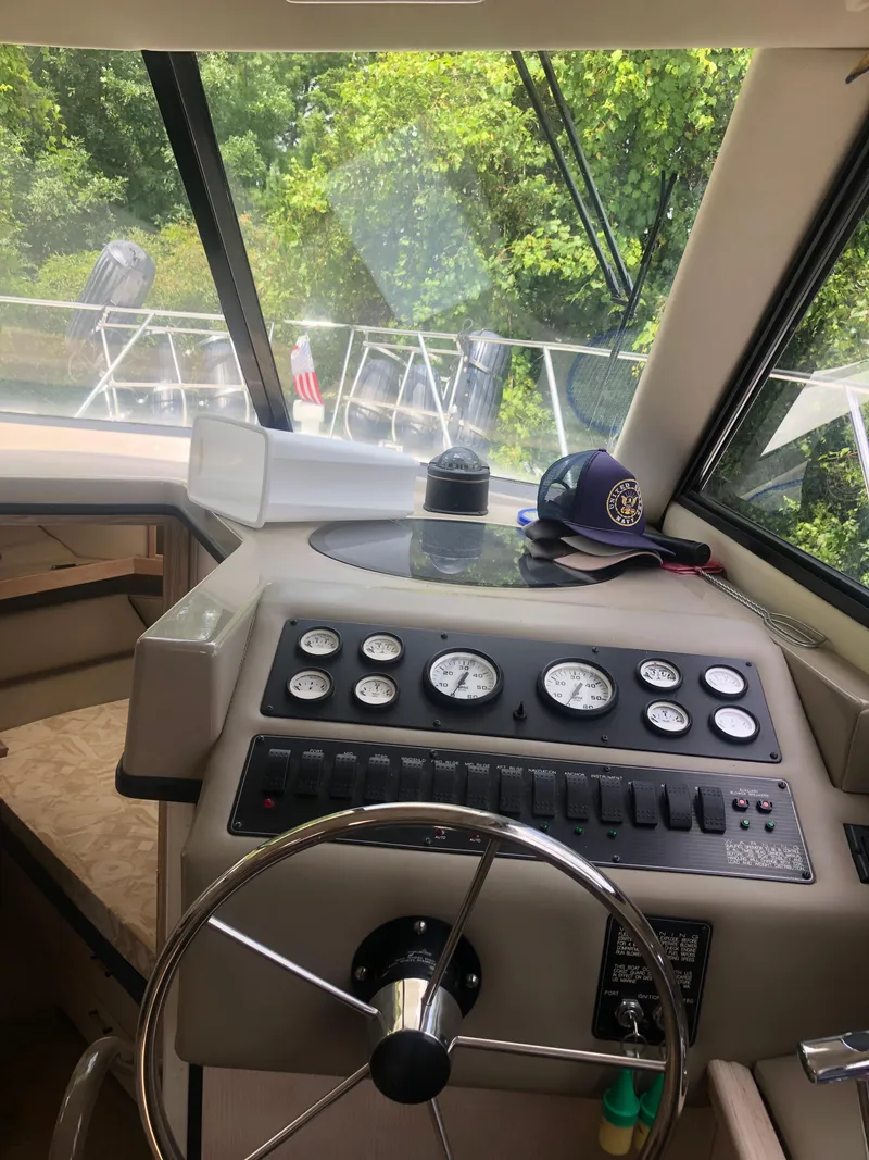 Slide: The Image of 1996 Bayliner 3587 Motoryacht helm with steering wheel and control panel. - 35
