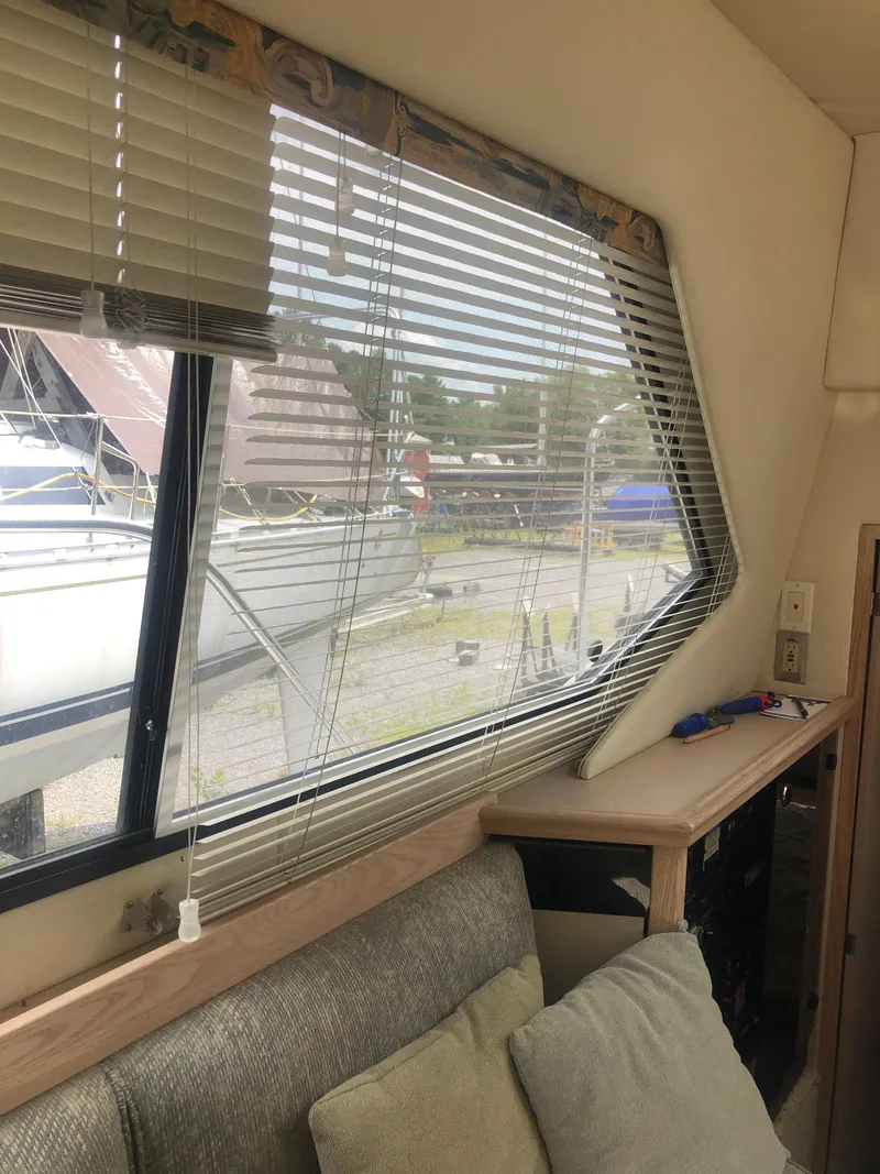 Slide: The Image of Interior view of 1996 Bayliner 3587 Motoryacht with window blinds and seating area. - 37