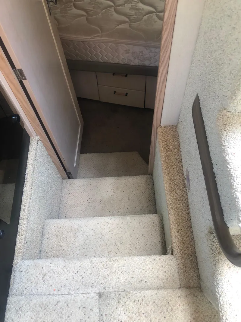 Slide: The Image of Staircase leading to cabin interior of 1996 Bayliner 3587 Motoryacht. - 38