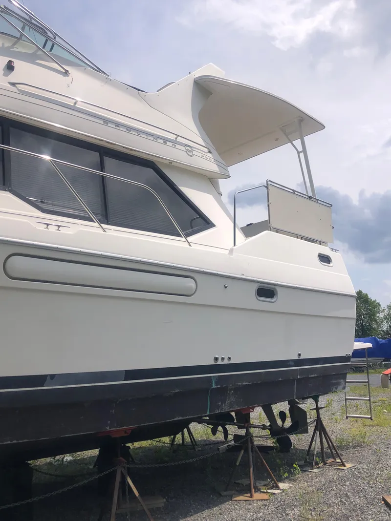 Slide: The Image of 1996 Bayliner 3587 Motoryacht on stands, side view under cloudy sky. - 4