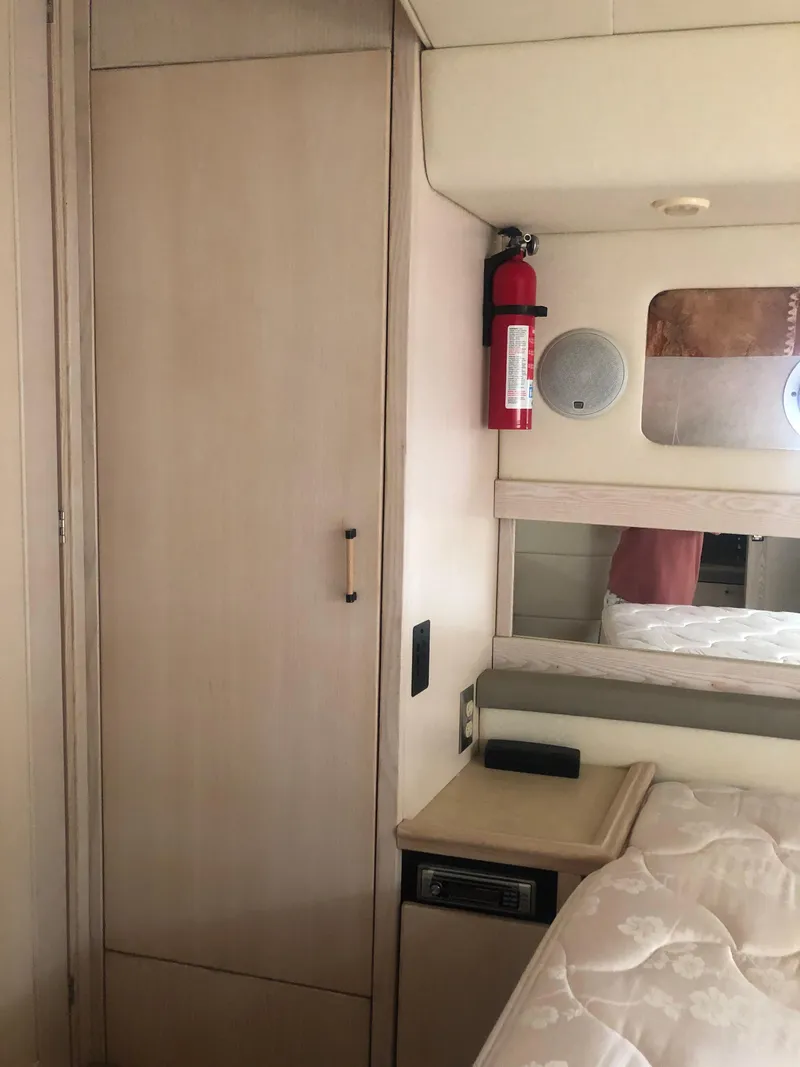 Slide: The Image of 1996 Bayliner 3587 Motoryacht interior with bed, cabinet, and fire extinguisher. - 46