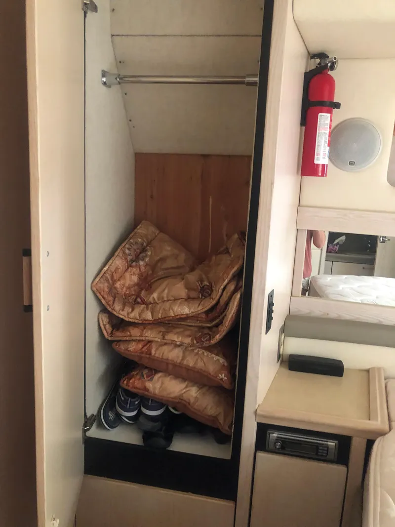 Slide: The Image of 1996 Bayliner 3587 Motoryacht interior closet with bedding and shoes. - 47