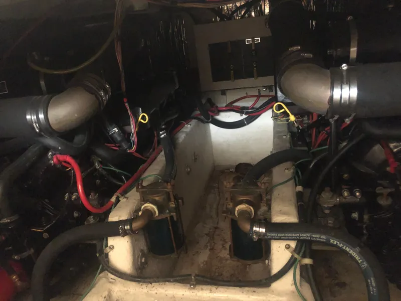 Slide: The Image of Engine room of a 1996 Bayliner 3587 Motoryacht with visible hoses and wiring. - 48