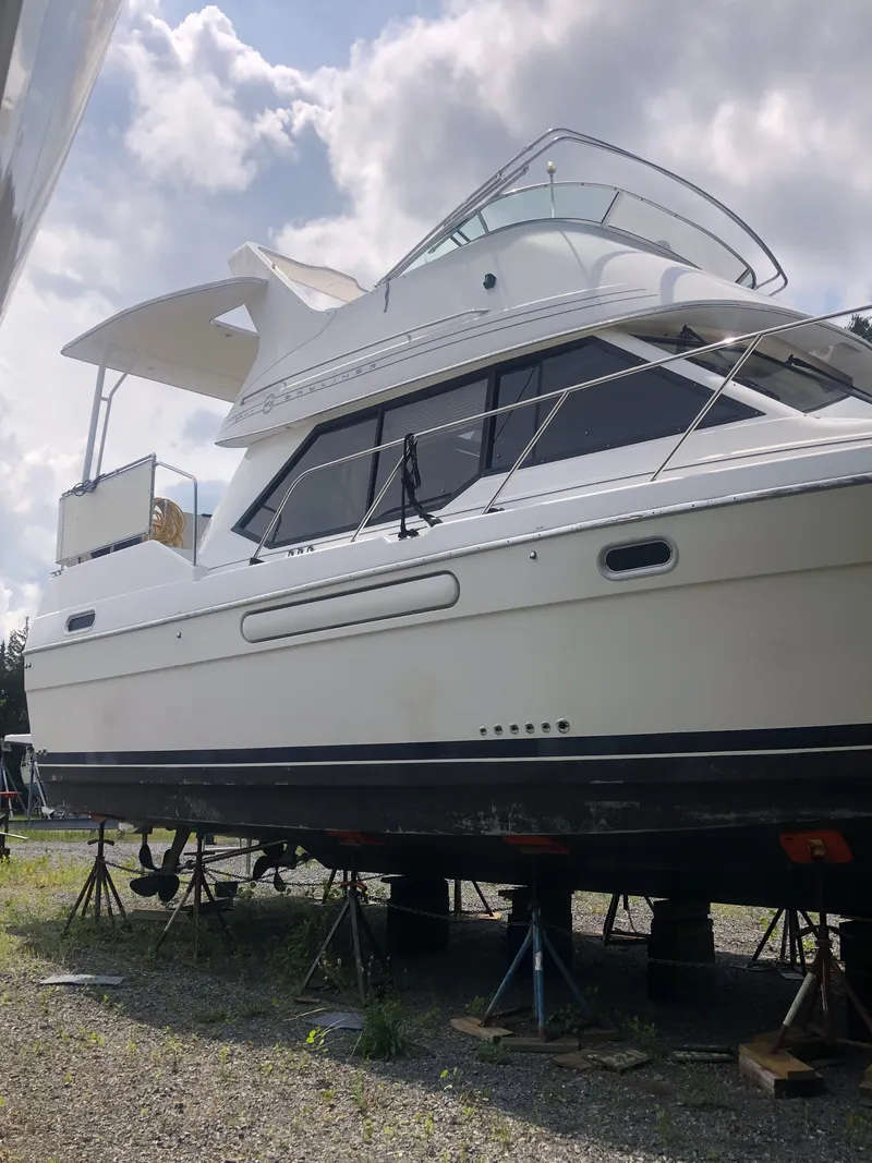 Slide: The Image of 1996 Bayliner 3587 Motoryacht on stands under cloudy sky. - 7