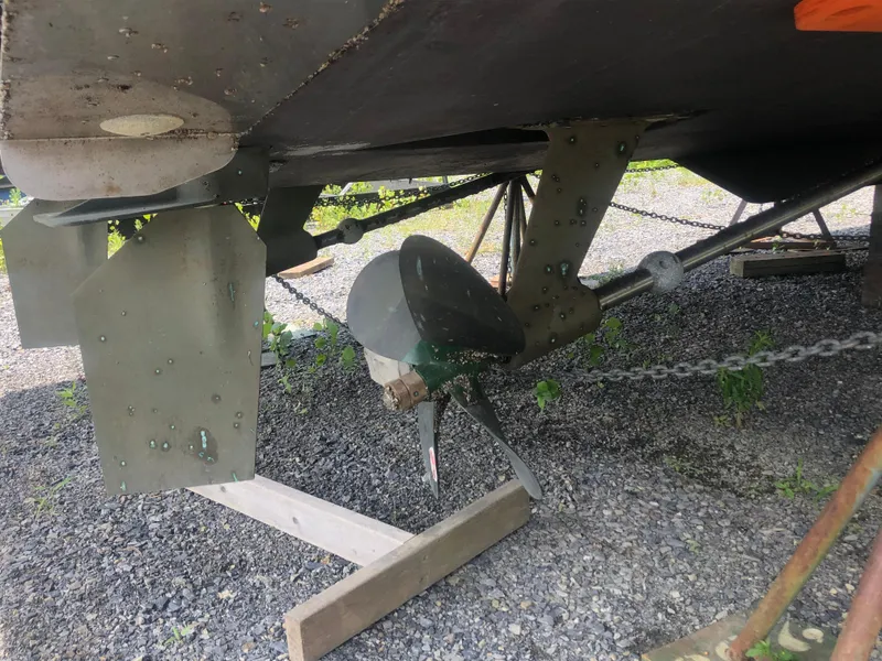 Slide: The Image of 1996 Bayliner 3587 Motoryacht underside with propeller and rudder on gravel. - 8