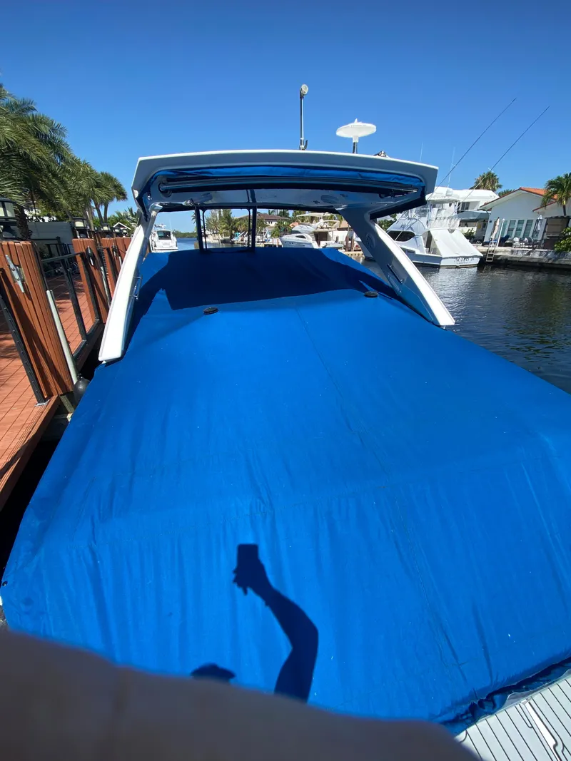 Slide: The Image of 2019 Monterey 378 Super Express boat covered with blue tarp at dock. - 16