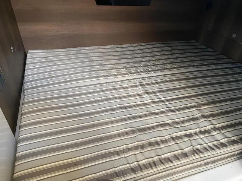 Slide: The Image of Striped mattress in the cabin of a 2019 Monterey 378 Super Express boat. - 17