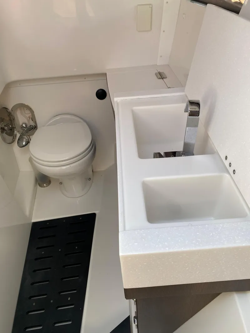 Slide: The Image of 2019 Monterey 378 Super Express boat bathroom with toilet and sink. - 22