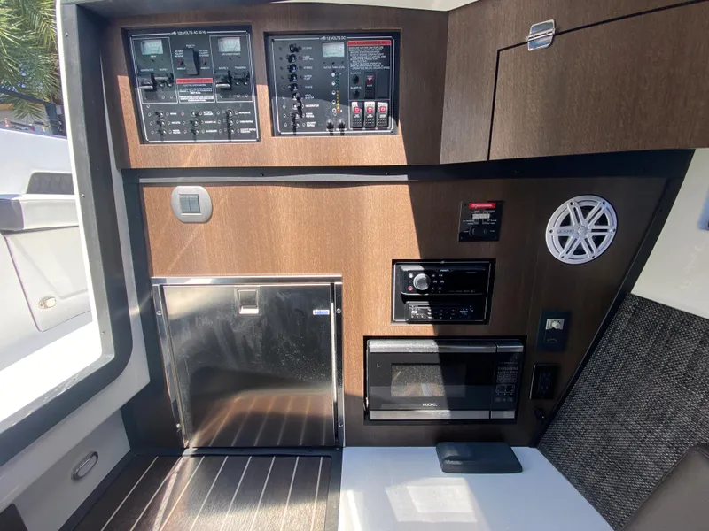 Slide: The Image of 2019 Monterey 378 Super Express control panel and galley area with microwave and stereo system. - 28