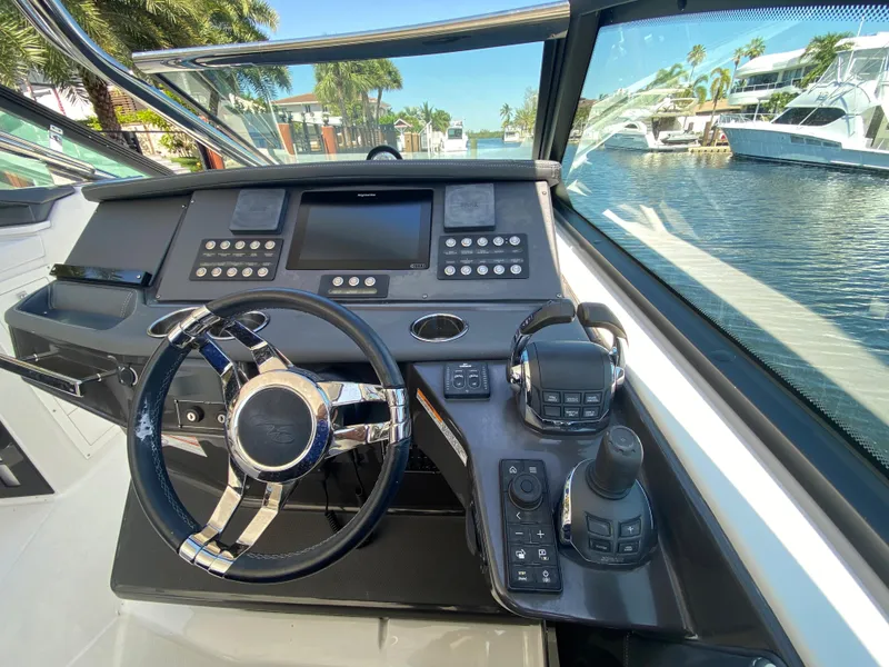 Slide: The Image of 2019 Monterey 378 Super Express boat helm with modern controls and waterfront view. - 29