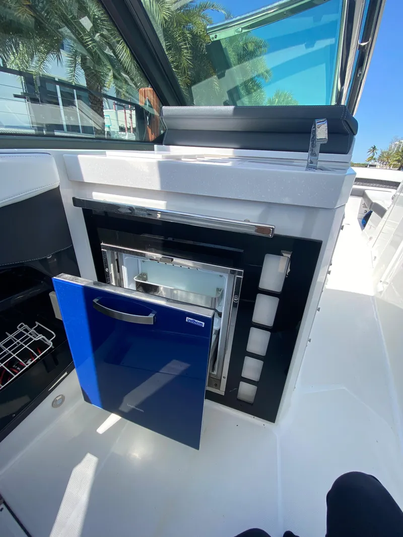 Slide: The Image of 2019 Monterey 378 Super Express boat interior with open blue cabinet. - 30