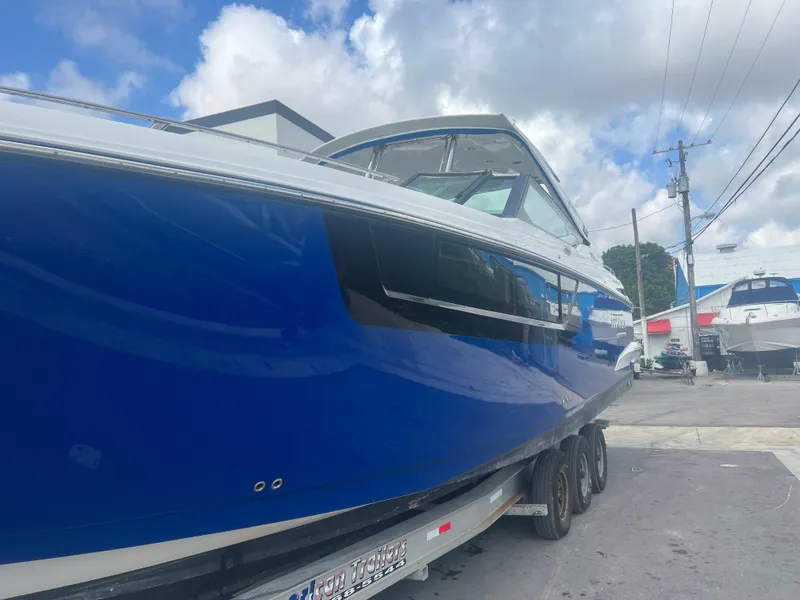 Slide: The Image of 2019 Monterey 378 Super Express boat in blue on a trailer. - 4