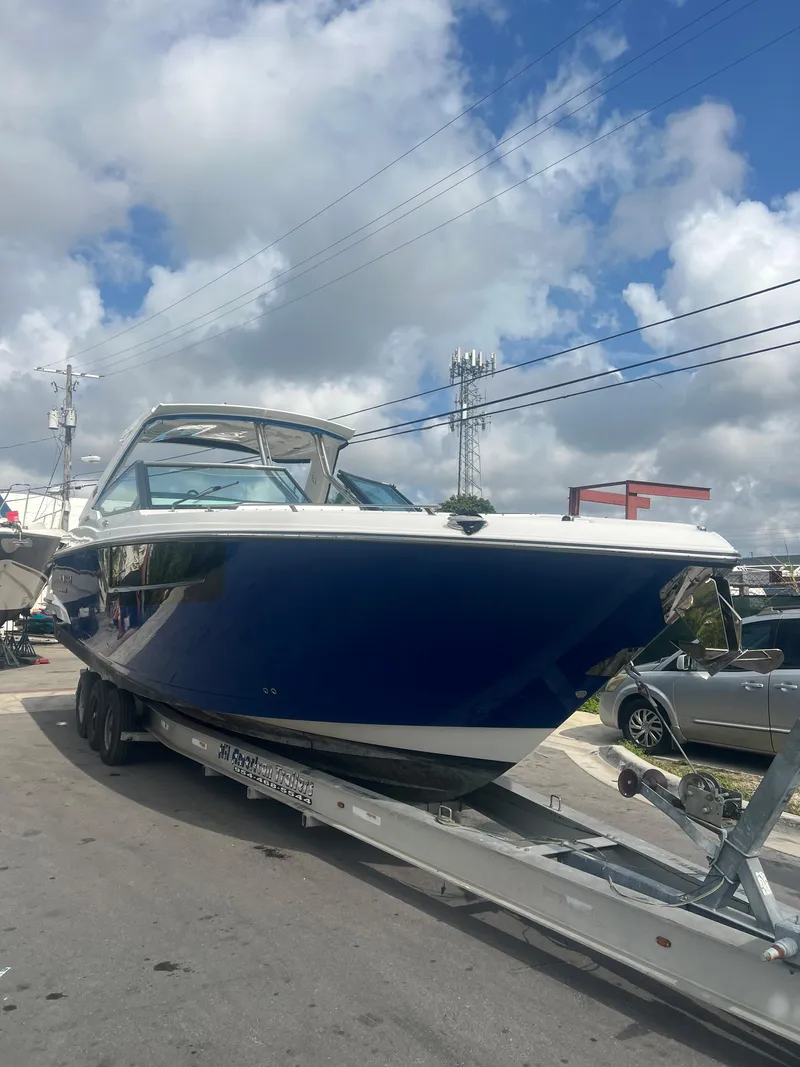 Slide: The Image of 2019 Monterey 378 Super Express boat on a trailer under a partly cloudy sky. - 6