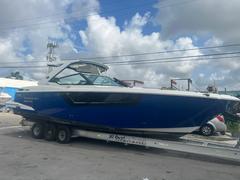 Slide: The Image of 2019 Monterey 378 Super Express boat on a trailer under a cloudy sky. - 7