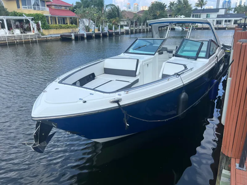 Slide: The Image of 2019 Monterey 378 Super Express boat docked in a scenic waterfront area. - 9