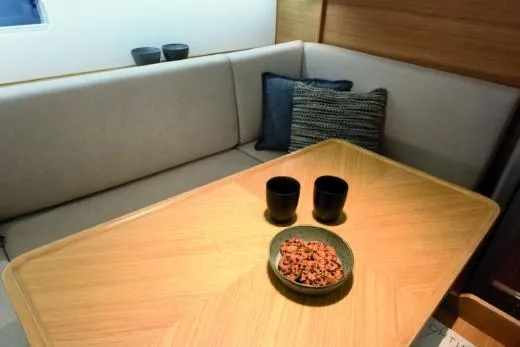 Slide: The Image of Interior of 2025 X-Yachts Pure X-4.3 with cozy seating and wooden table. - 11