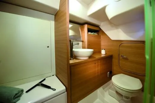 Slide: The Image of Luxurious bathroom in 2025 X-Yachts Pure X-4.3, featuring modern fixtures and wooden cabinetry. - 9