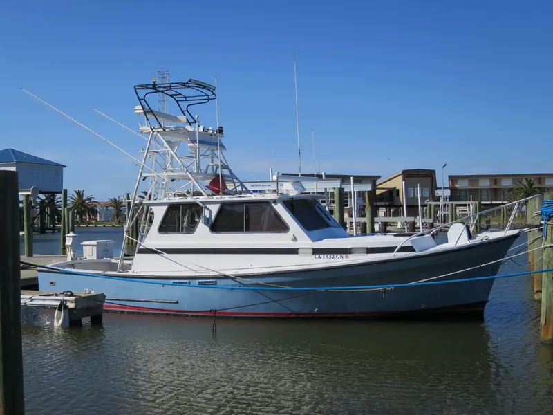 The Image of 1999 Eastern 35 boat docked at a marina on a sunny day. - 0