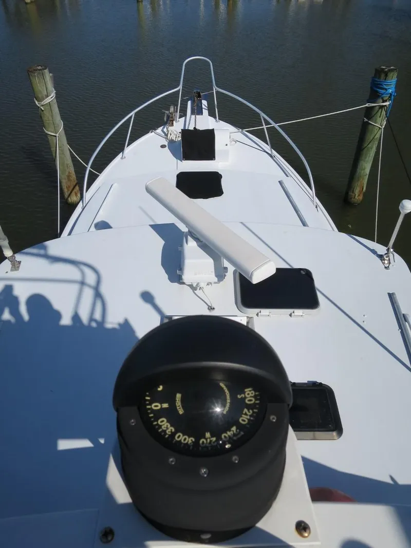 Slide: The Image of 1999 Eastern 35 boat deck with compass and docked at marina. - 3