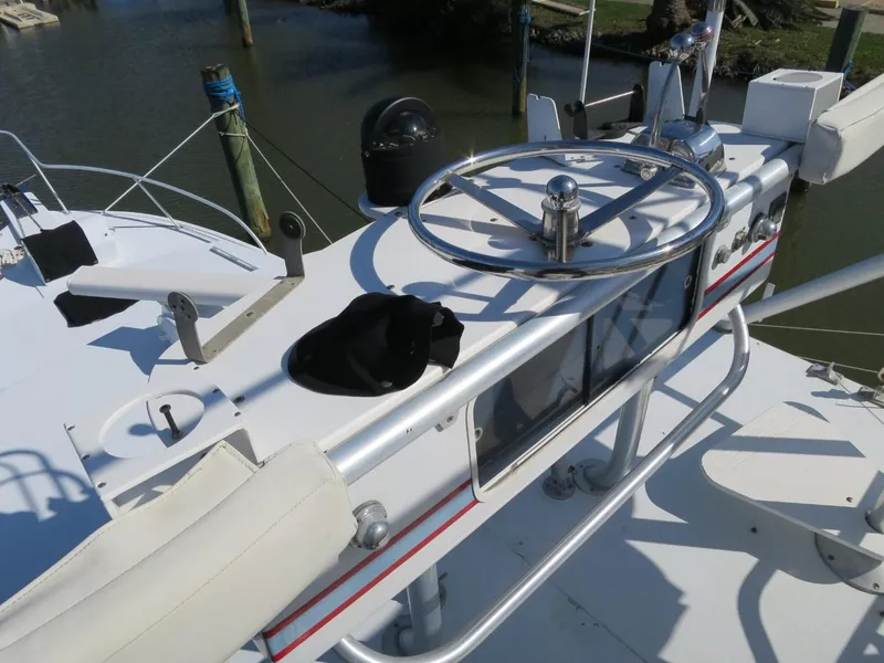 Slide: The Image of Control deck of a 1999 Eastern 35 boat with steering wheel and navigation equipment. - 4
