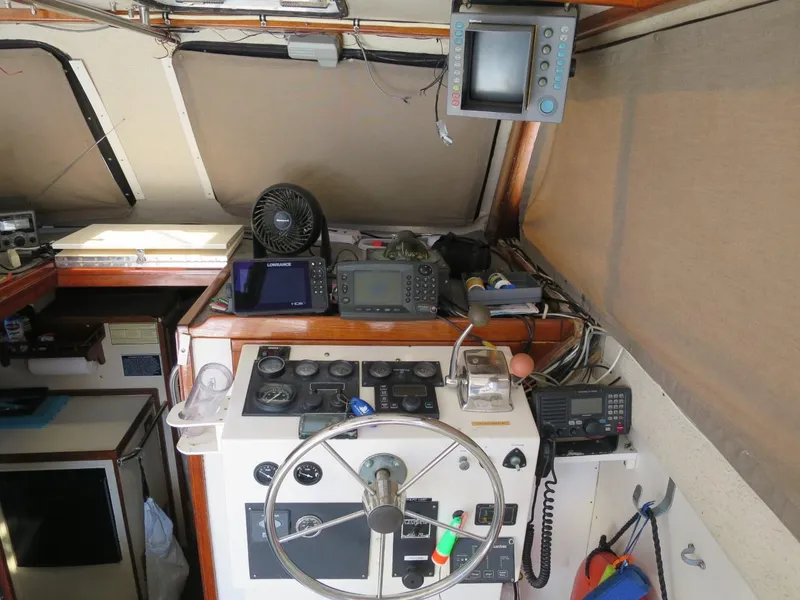Slide: The Image of 1999 Eastern 35 boat cockpit with navigation equipment and steering wheel. - 6