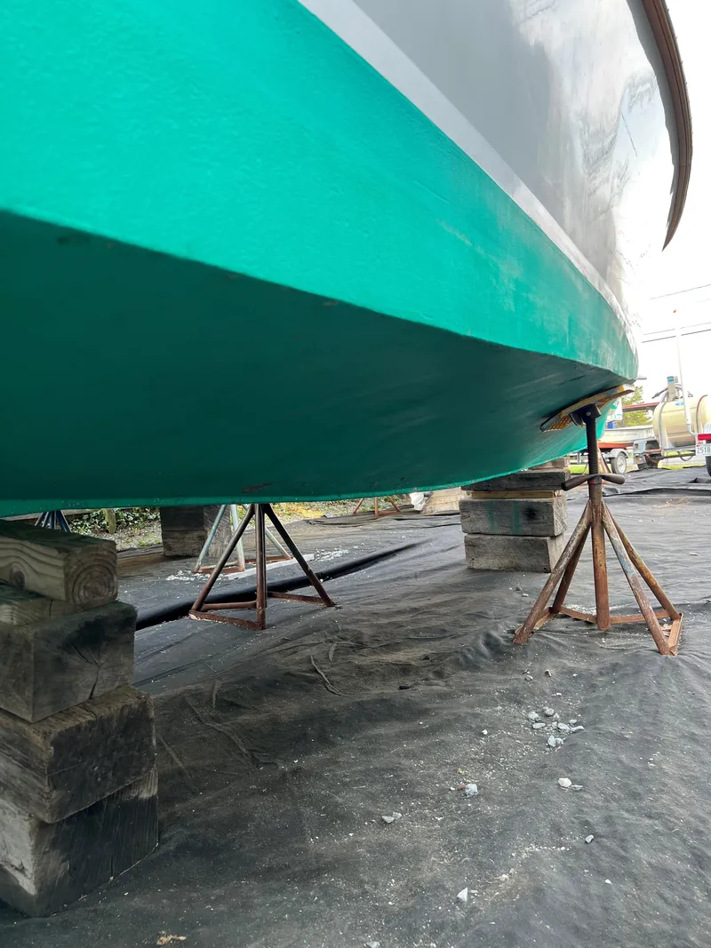 Slide: The Image of 1987 Custom Vansant 30 boat on stands for maintenance. - 11