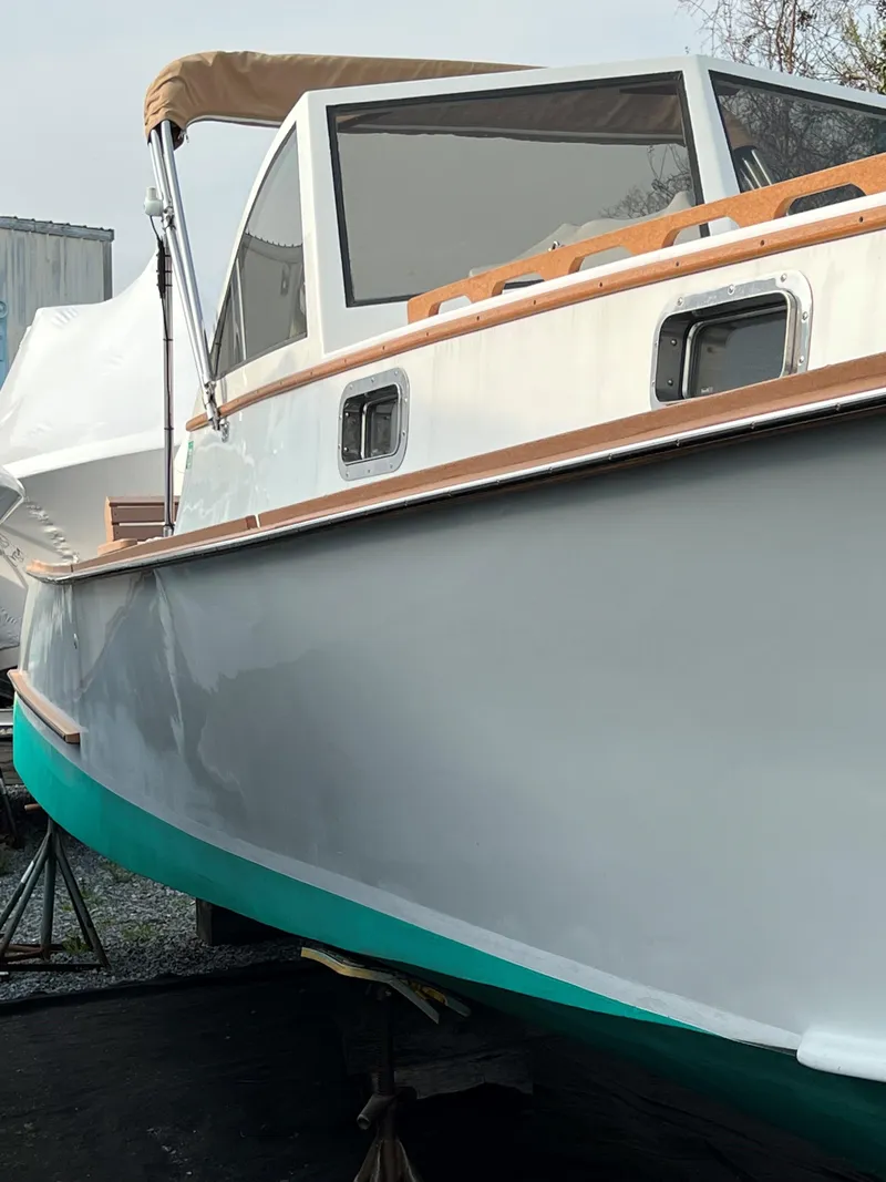 Slide: The Image of 1987 Custom Vansant 30 boat with teal hull and tan canopy. - 13