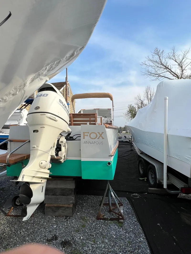 Slide: The Image of Custom Vansant 30 boat, 1987 model, docked with outboard motor, Fox Annapolis on the stern. - 16