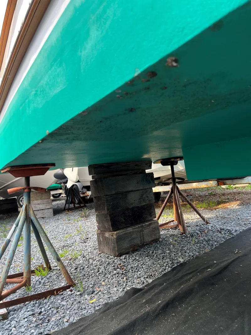 Slide: The Image of 1987 Custom Vansant 30 boat hull on supports for maintenance. - 18