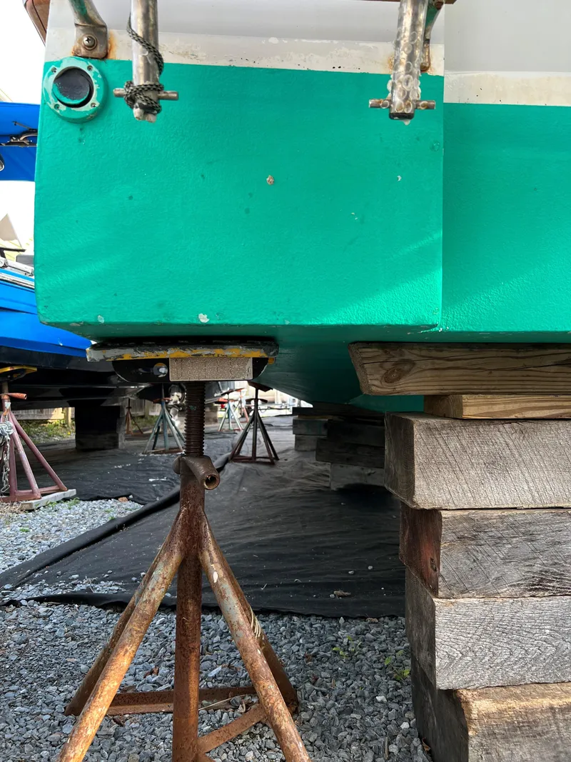 Slide: The Image of Green Custom Vansant 30 boat from 1987 on stands for maintenance. - 20