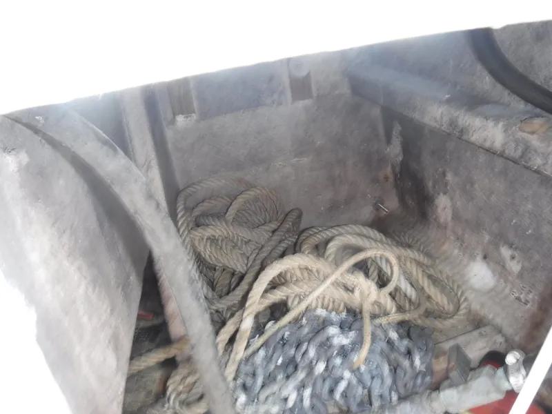Slide: The Image of Anchor locker of 1987 Custom Vansant 30 with ropes and chains. - 24