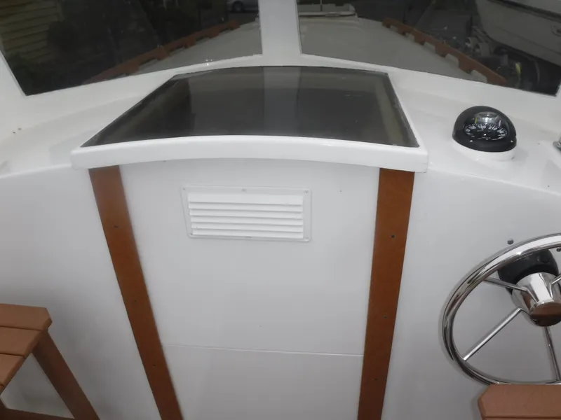 Slide: The Image of 1987 Custom Vansant 30 boat helm with steering wheel and navigation equipment. - 26