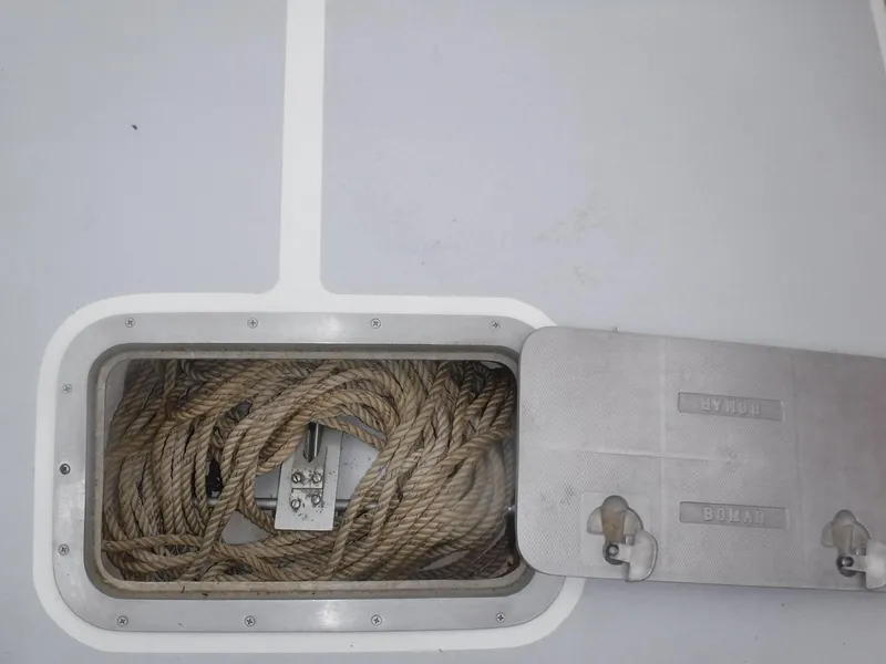 Slide: The Image of Open storage compartment with coiled rope on a 1987 Custom Vansant 30 boat. - 28