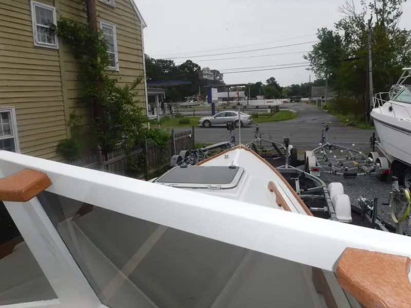 Slide: The Image of Custom Vansant 30 boat from 1987 on a trailer in a residential area. - 31