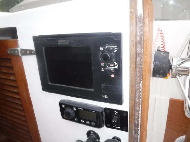 Slide: The Image of Control panel of a 1987 Custom Vansant 30 boat with navigation and communication equipment. - 32