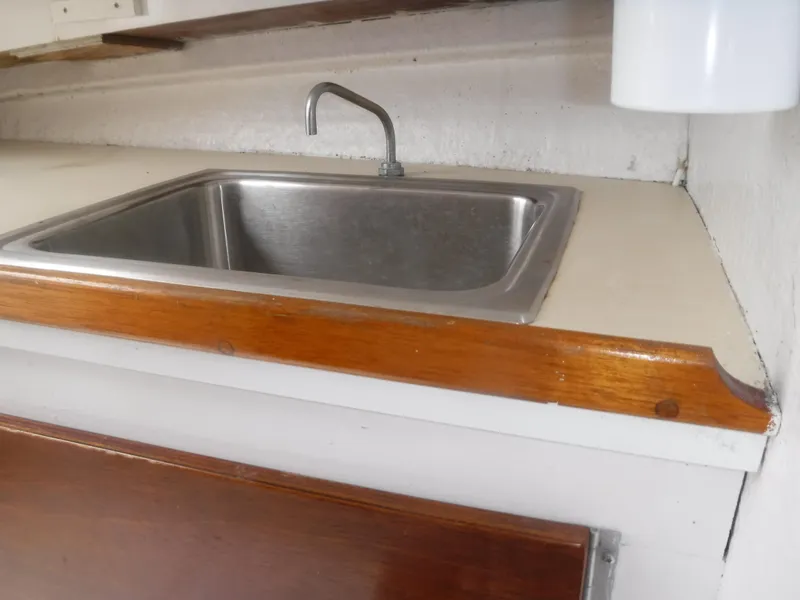Slide: The Image of Stainless steel sink in the galley of a 1987 Custom Vansant 30 boat. - 38