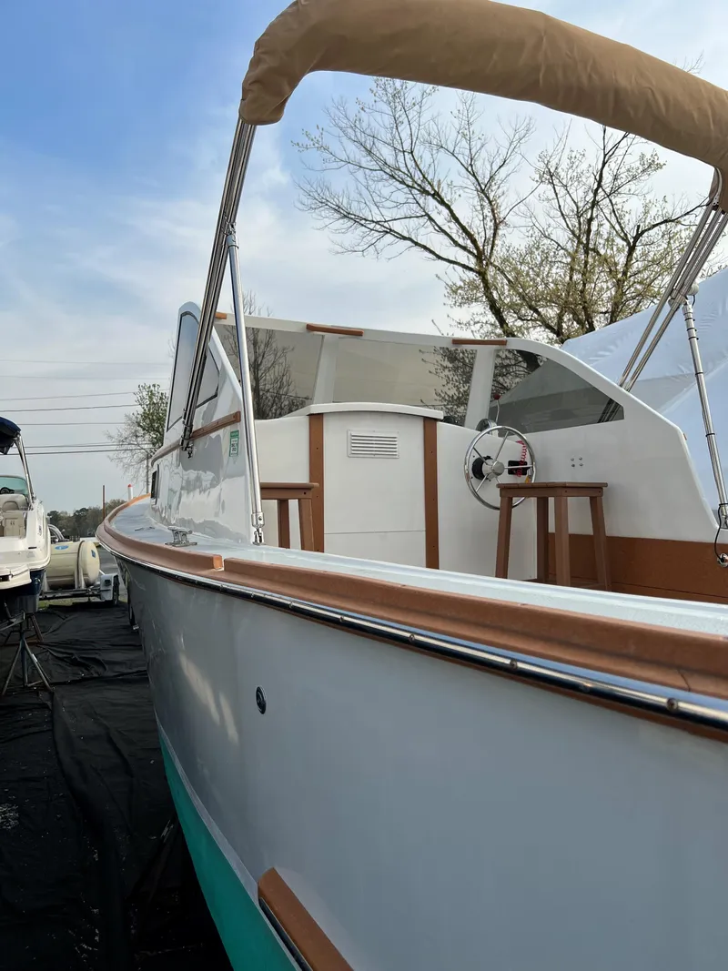 Slide: The Image of 1987 Custom Vansant 30 boat with wooden trim and canopy, docked outdoors. - 8