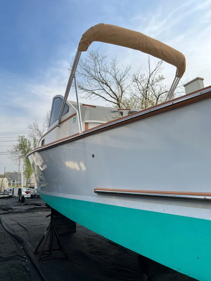 Slide: The Image of 1987 Custom Vansant 30 boat with teal hull and tan canopy. - 9