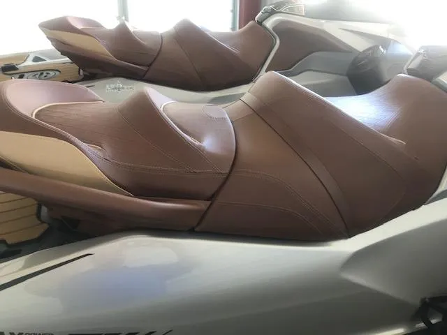 Slide: The Image of 2019 Sea-Doo RXT jet ski with brown leather seats. - 2