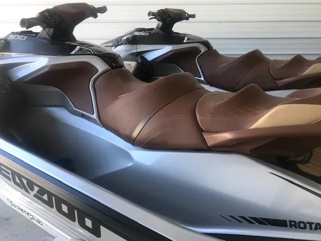 Slide: The Image of 2019 Sea-Doo RXT jet skis with brown seats in storage. - 4