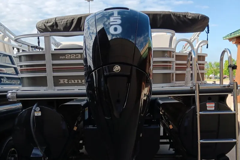 Slide: The Image of 2023 Ranger 223F pontoon boat with a 150 HP Mercury outboard motor. - 2