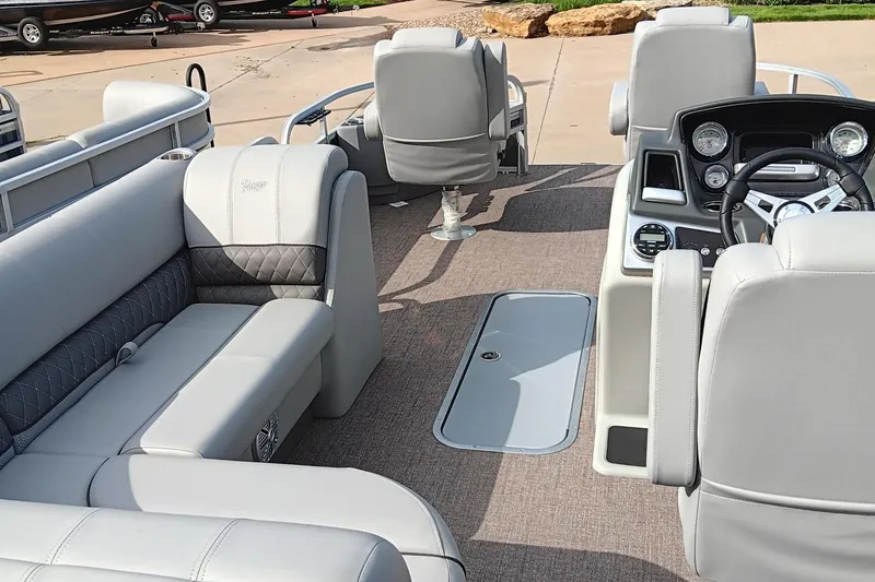 Slide: The Image of 2023 Ranger 223F boat interior with gray seating and modern dashboard. - 5
