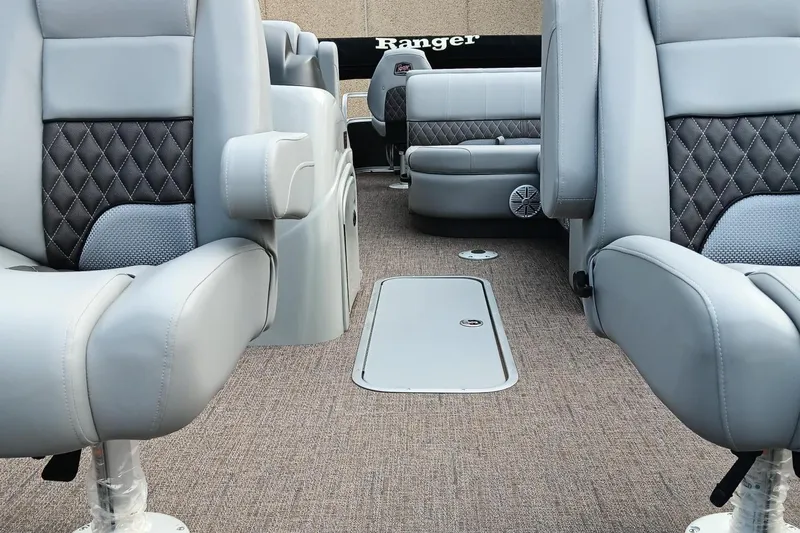 Slide: The Image of 2023 Ranger 223F boat interior with luxurious seating and carpeted flooring. - 6