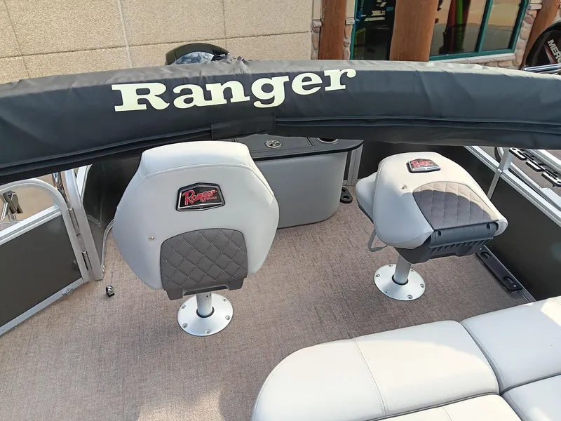 Slide: The Image of 2023 Ranger 223F boat interior with cushioned seats and Ranger branding. - 7