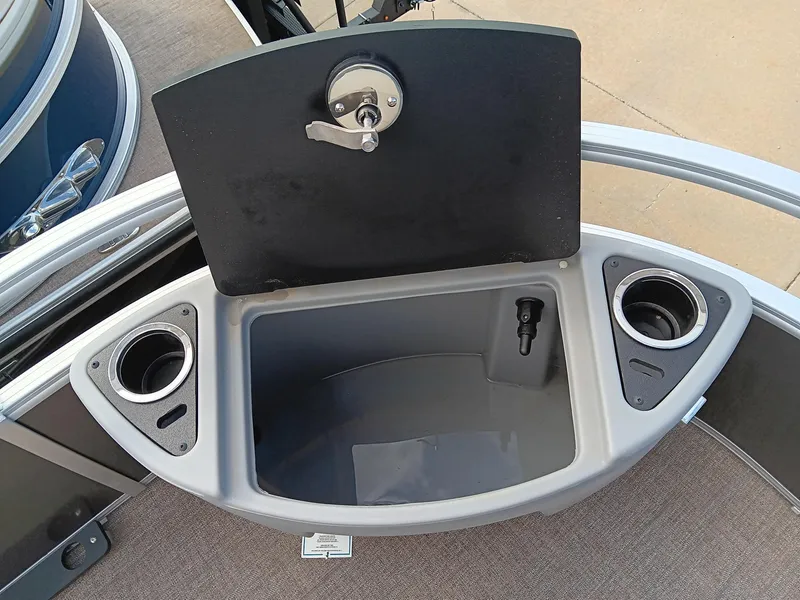 Slide: The Image of 2023 Ranger 223F boat storage compartment with cup holders and lockable lid. - 9