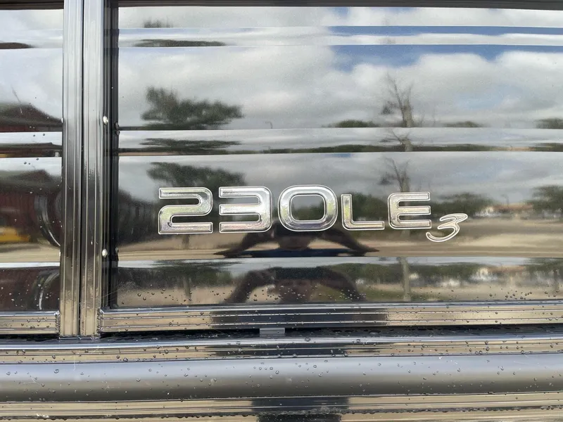 Slide: The Image of 2023 Regency 230 LE3 model emblem on reflective surface - 1