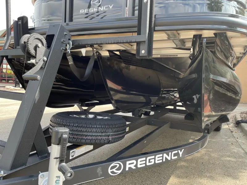 Slide: The Image of 2023 Regency 230 LE3 pontoon boat on trailer, close-up view. - 13